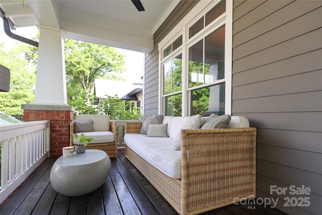 wooden deck featuring a porch and ceiling fan