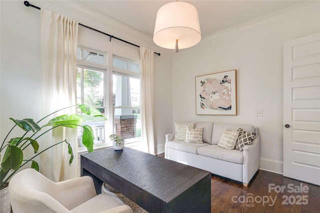 living area with baseboards, dark wood finished floors, and crown molding