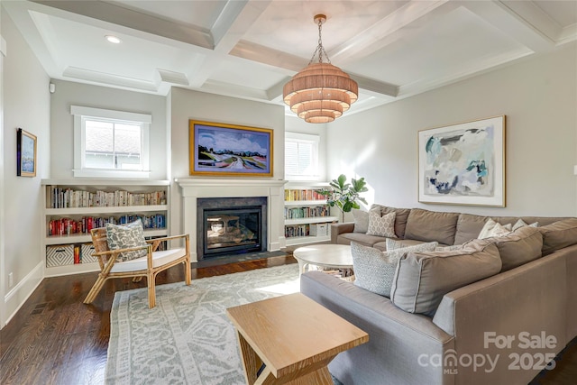 living area with a wealth of natural light, beamed ceiling, coffered ceiling, and wood finished floors