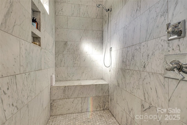 bathroom with a tile shower