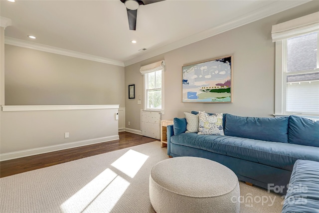 living area featuring wood finished floors, baseboards, ornamental molding, and recessed lighting