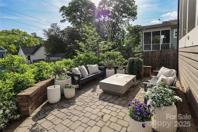 view of patio featuring an outdoor hangout area and fence