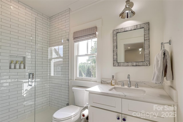 full bathroom featuring a stall shower, vanity, and toilet
