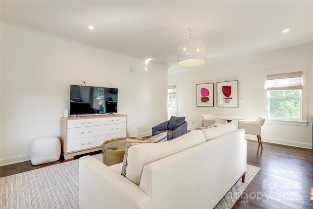 living room with crown molding, baseboards, and dark wood finished floors