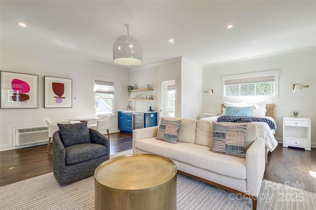 bedroom featuring a sink, wine cooler, ornamental molding, and wood finished floors
