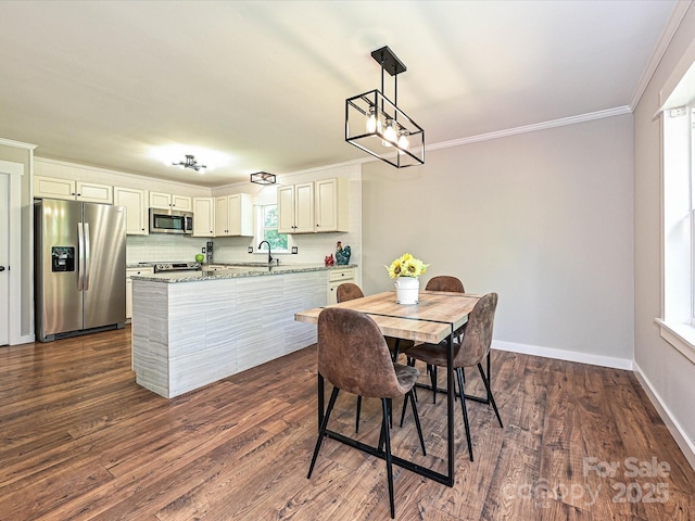 dining room featuring crown molding, baseboards, and dark wood-style flooring