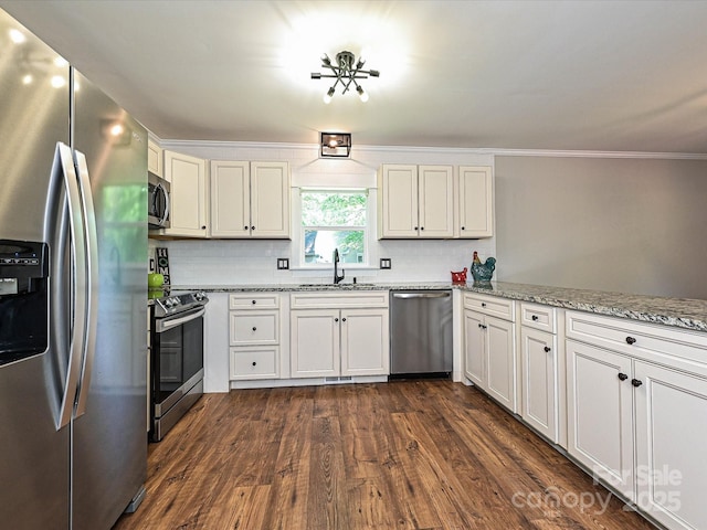 kitchen with tasteful backsplash, a sink, light stone counters, stainless steel appliances, and dark wood-type flooring