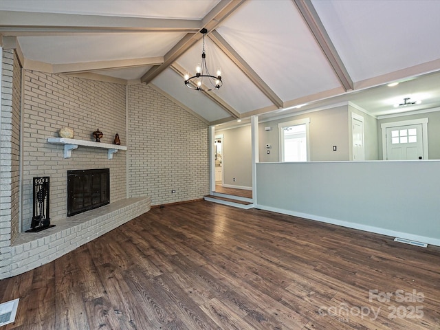 unfurnished living room featuring brick wall, a fireplace, wood finished floors, lofted ceiling with beams, and a chandelier