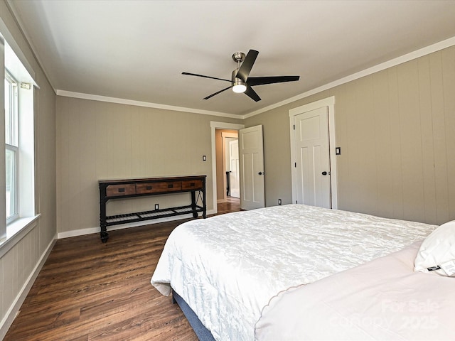 bedroom with dark wood-style flooring, a ceiling fan, ornamental molding, and baseboards