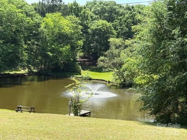 view of water feature with a forest view