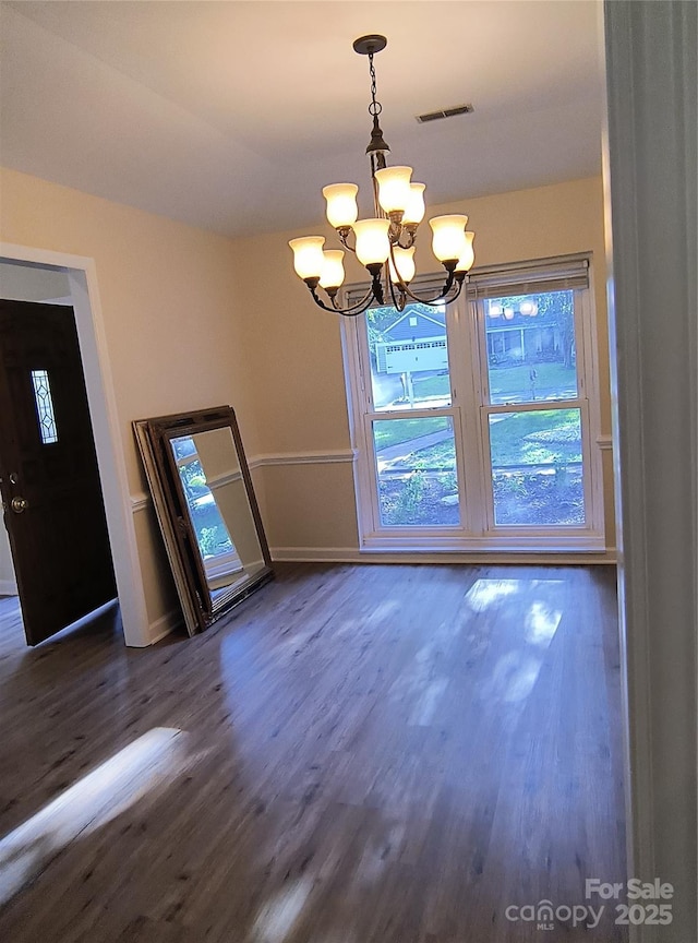 5601 Carmel Station Ave, Charlotte, NC 28226 - unfurnished dining area with a chandelier, dark wood-style floors, plenty of natural light, and baseboards