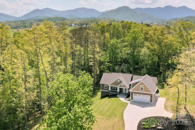 bird's eye view featuring a forest view and a mountain view