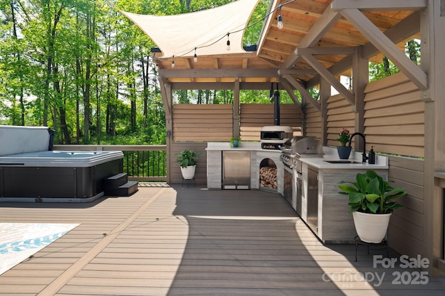 wooden deck with a sink, a hot tub, area for grilling, and a grill