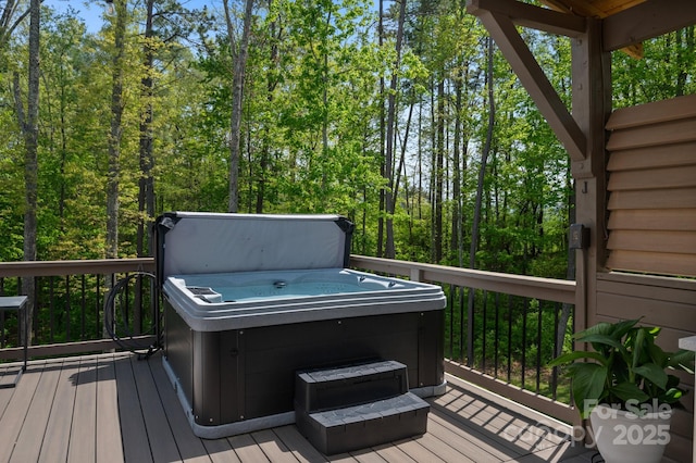 wooden deck with a hot tub