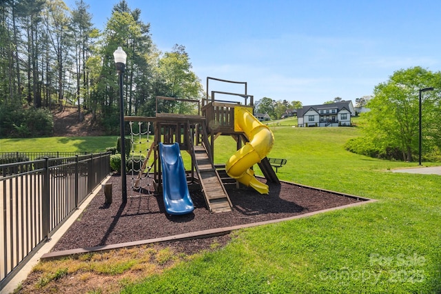 communal playground with fence and a yard