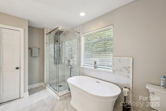 3223 Rheinwood Ct, Matthews, NC 28105 - bathroom featuring healthy amount of natural light, a stall shower, a freestanding bath, and marble finish floors