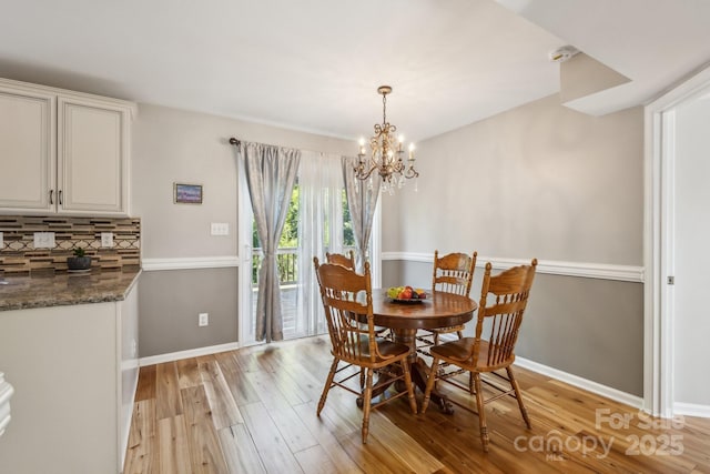 3223 Rheinwood Ct, Matthews, NC 28105 - dining area featuring light wood finished floors, baseboards, and a chandelier