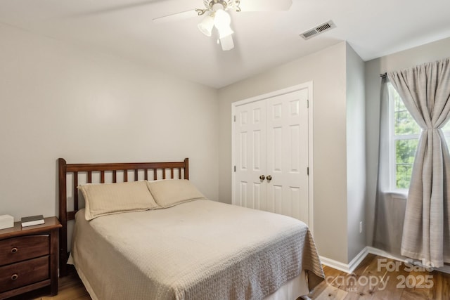 3223 Rheinwood Ct, Matthews, NC 28105 - bedroom with wood finished floors, baseboards, a closet, and a ceiling fan