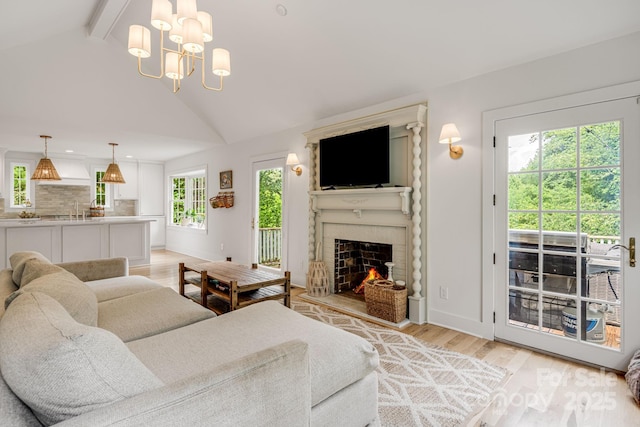 92 Rose Hill Rd, Asheville, NC 28803 - living area featuring light wood-type flooring, a fireplace, a chandelier, and baseboards