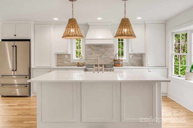 92 Rose Hill Rd, Asheville, NC 28803 - kitchen with high quality fridge, premium range hood, light countertops, white cabinets, and recessed lighting