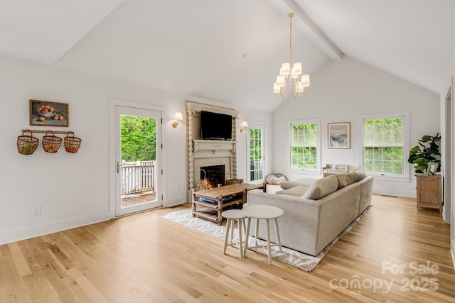 92 Rose Hill Rd, Asheville, NC 28803 - living area featuring plenty of natural light, a warm lit fireplace, wood finished floors, and a chandelier