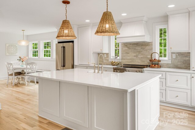 92 Rose Hill Rd, Asheville, NC 28803 - kitchen featuring high end refrigerator, custom range hood, light countertops, decorative backsplash, and recessed lighting