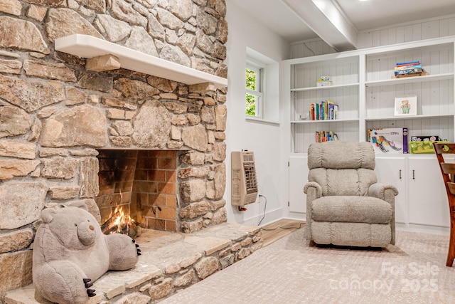 92 Rose Hill Rd, Asheville, NC 28803 - sitting room with heating unit, a stone fireplace, and wood finished floors