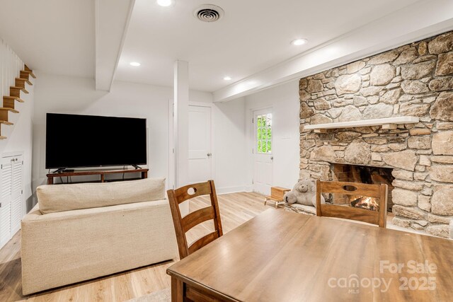92 Rose Hill Rd, Asheville, NC 28803 - dining area with light wood-type flooring, beam ceiling, stairs, recessed lighting, and a stone fireplace