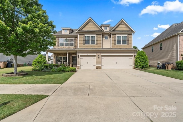 1011 Potomac Rd, Indian Trail, NC 28079 - craftsman-style house featuring an attached garage, concrete driveway, a front lawn, and stone siding