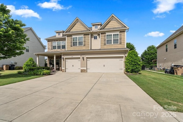 1011 Potomac Rd, Indian Trail, NC 28079 - craftsman-style home featuring a garage, concrete driveway, stone siding, and a front lawn