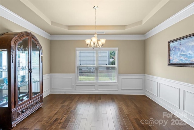 1011 Potomac Rd, Indian Trail, NC 28079 - unfurnished dining area with a tray ceiling, a chandelier, wainscoting, and dark wood-style flooring