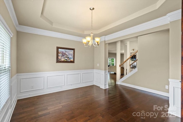 1011 Potomac Rd, Indian Trail, NC 28079 - spare room with a chandelier, a raised ceiling, dark wood finished floors, wainscoting, and stairway