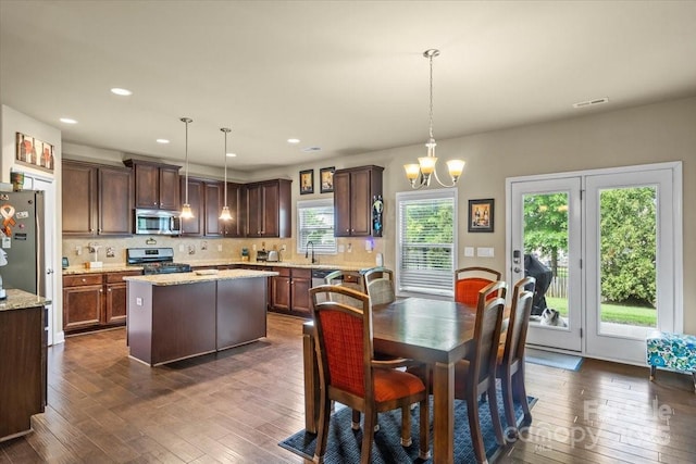 1011 Potomac Rd, Indian Trail, NC 28079 - kitchen featuring stainless steel appliances, dark wood-type flooring, dark brown cabinets, a kitchen island, and a chandelier