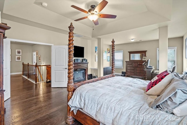 1011 Potomac Rd, Indian Trail, NC 28079 - bedroom with dark wood-style flooring, ceiling fan, a glass covered fireplace, and baseboards