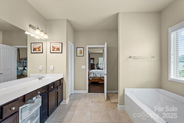 1011 Potomac Rd, Indian Trail, NC 28079 - ensuite bathroom featuring plenty of natural light, a bath, baseboards, and tile patterned flooring