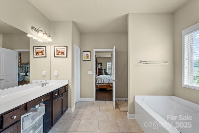 1011 Potomac Rd, Indian Trail, NC 28079 - bathroom featuring connected bathroom, vanity, a bath, and plenty of natural light