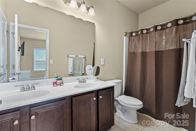 1011 Potomac Rd, Indian Trail, NC 28079 - full bathroom with double vanity, tile patterned flooring, and a shower with shower curtain