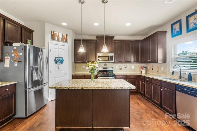 1011 Potomac Rd, Indian Trail, NC 28079 - kitchen with stainless steel appliances, dark brown cabinets, a kitchen island, dark wood-style floors, and recessed lighting