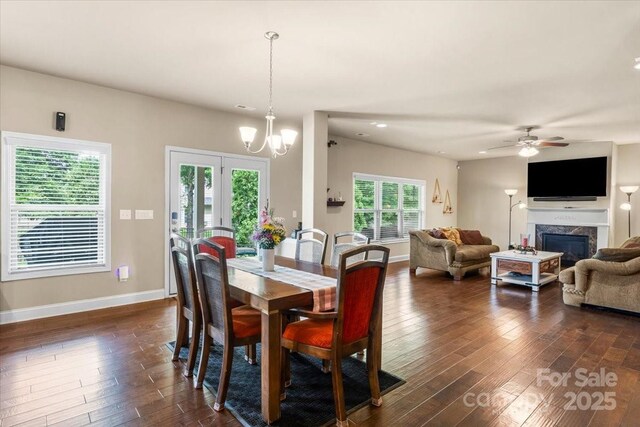 1011 Potomac Rd, Indian Trail, NC 28079 - dining area featuring dark wood-type flooring, a high end fireplace, ceiling fan, a chandelier, and recessed lighting