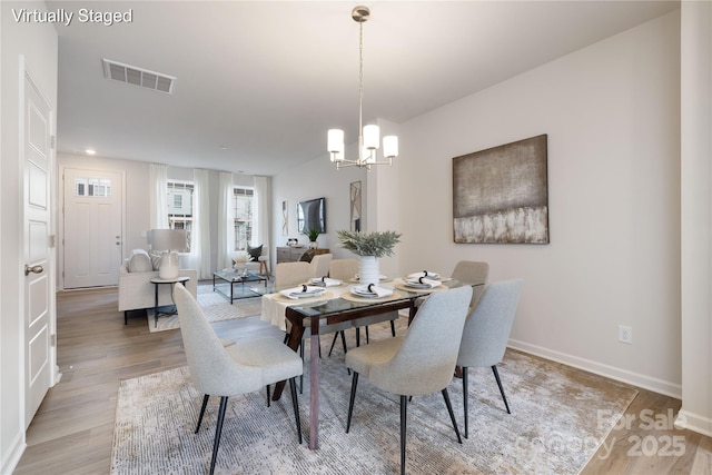 8118 Jacey Ln Unit 20, Huntersville, NC 28078 - dining area with visible vents, light wood-style flooring, baseboards, and a chandelier