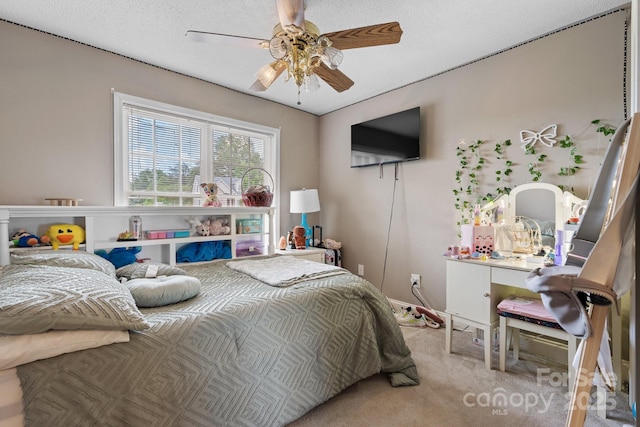 bedroom featuring ceiling fan and carpet