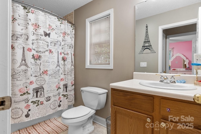 bathroom with vanity, a textured ceiling, curtained shower, and toilet