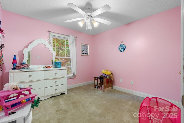 playroom featuring ceiling fan, light carpet, and baseboards