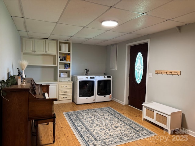 laundry room with separate washer and dryer, light wood-style floors, and baseboards