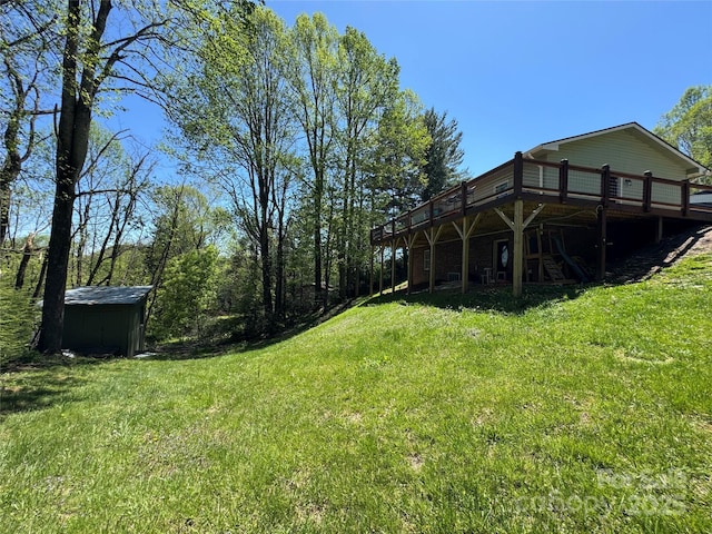 view of yard with an outdoor structure, a shed, and a deck