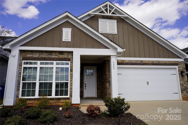 craftsman inspired home featuring board and batten siding, driveway, stone siding, and a garage