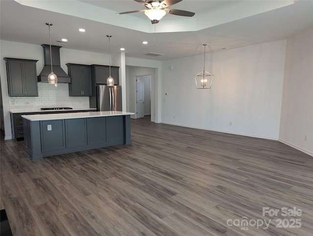 kitchen featuring light countertops, premium range hood, freestanding refrigerator, a ceiling fan, and recessed lighting