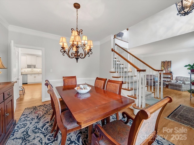3133 English Sparrow Ln, Charlotte, NC 28210 - dining room with stairs, light wood-style floors, a chandelier, and crown molding