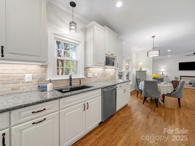 3133 English Sparrow Ln, Charlotte, NC 28210 - kitchen featuring a sink, crown molding, open floor plan, white cabinets, and stainless steel dishwasher