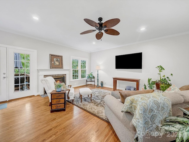 3133 English Sparrow Ln, Charlotte, NC 28210 - living room with a ceiling fan, a healthy amount of sunlight, a high end fireplace, and crown molding